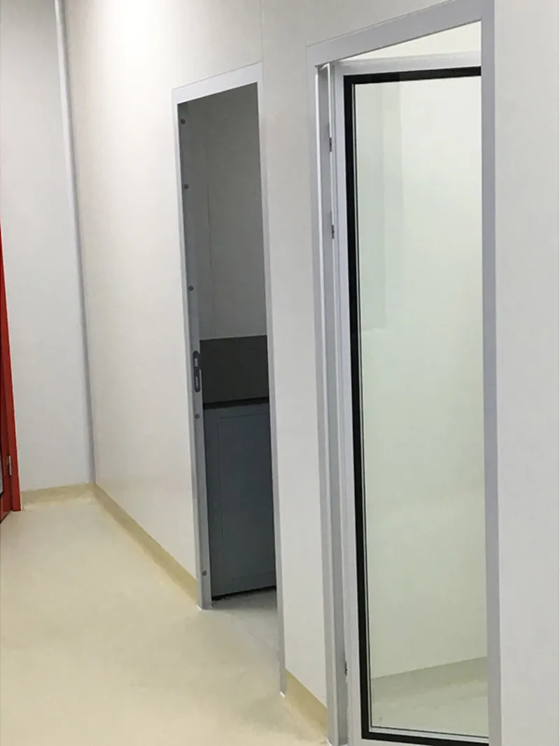 Clean room glass door in operation within pharmaceutical cleanroom with full glass partition wall