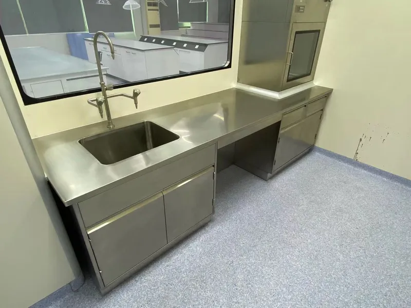 Stainless steel lab table with integrated sink installed inside a prefabricated cleanroom with ceiling grid system and cleanroom partition walls